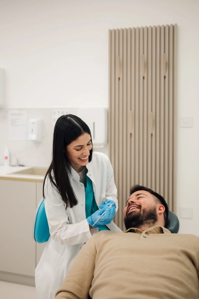 Smiling dentist consults with a happy male patient at Clearly Dental Dapto in a modern surgery room