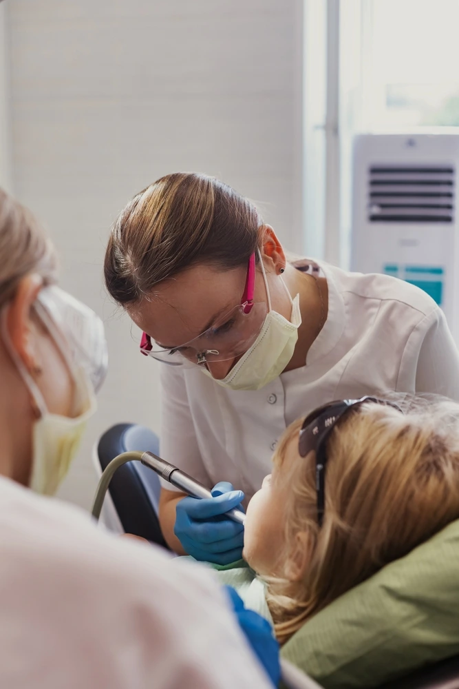 Clearly Dental Dapto team performs a gentle, focus-driven dental procedure on a young child.