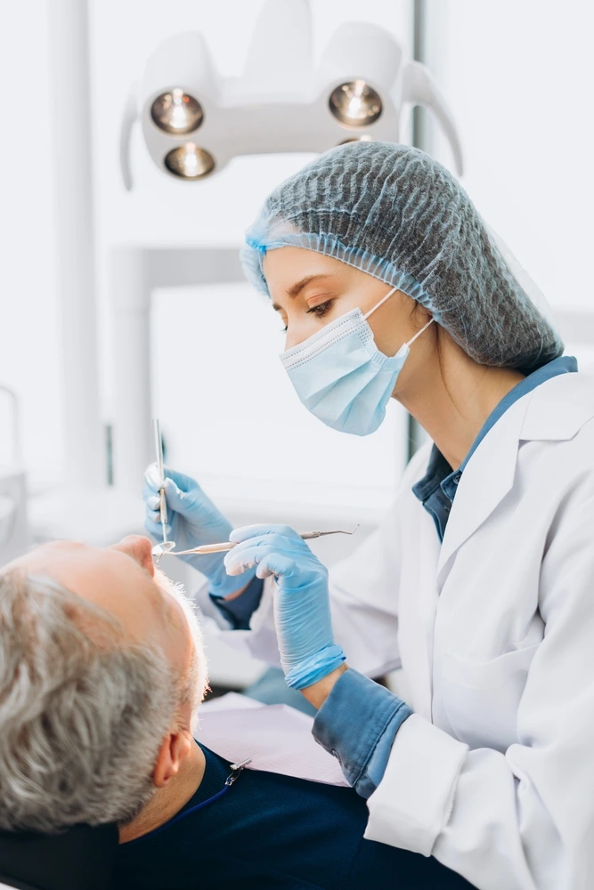 Clearly Dental Dapto dentist performing a thorough check-up on an older male patient.