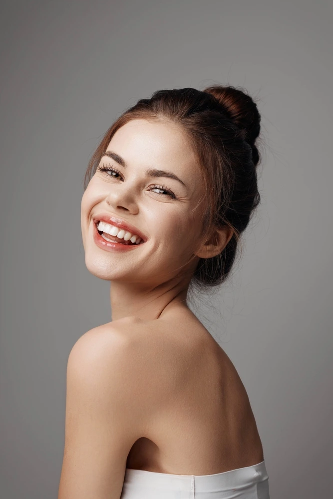 Happy woman with a brilliant, wide smile showcasing results from Clearly Dental Dapto.